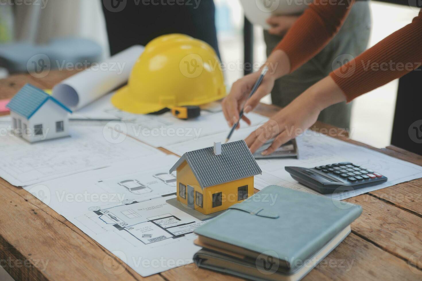 Engineer Teamwork Meeting, Drawing working on blueprint meeting for project working with partner on model building and engineering tools in working site, Construction and structure concept. photo