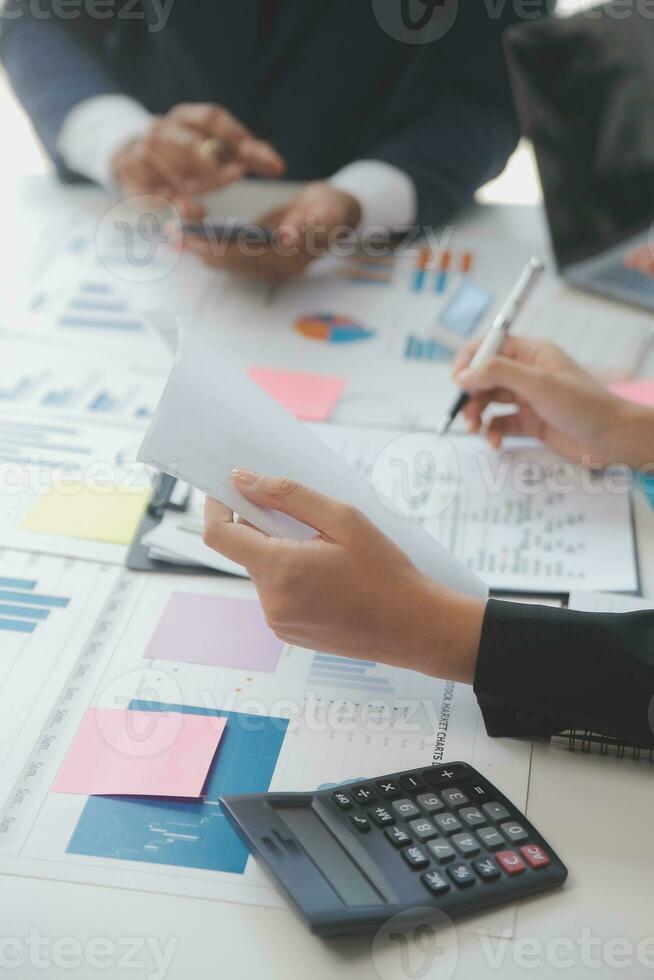 Financial analysts analyze business financial reports on a digital tablet planning investment project during a discussion at a meeting of corporate showing the results of their successful teamwork. photo