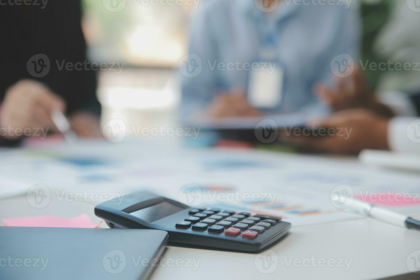 Financial analysts analyze business financial reports on a digital tablet planning investment project during a discussion at a meeting of corporate showing the results of their successful teamwork. photo