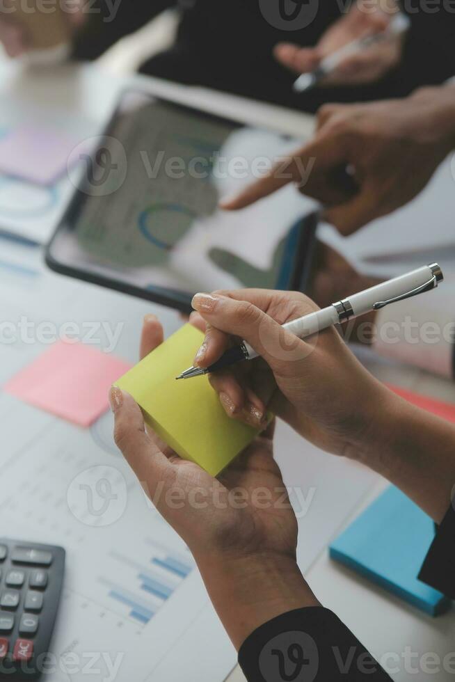 Financial analysts analyze business financial reports on a digital tablet planning investment project during a discussion at a meeting of corporate showing the results of their successful teamwork. photo