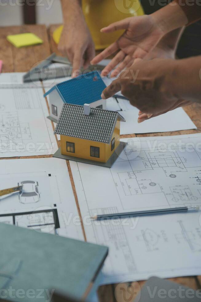 Construction and structure concept of engineer working drawing on blueprint meeting for project working with partner on model building and engineering tools in working site, construction concept. photo