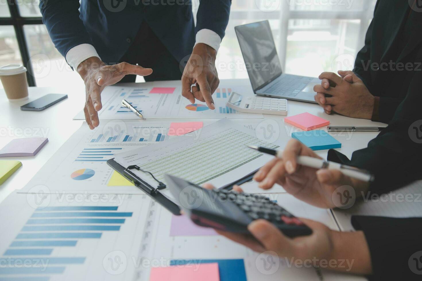 Financial analysts analyze business financial reports on a digital tablet planning investment project during a discussion at a meeting of corporate showing the results of their successful teamwork. photo