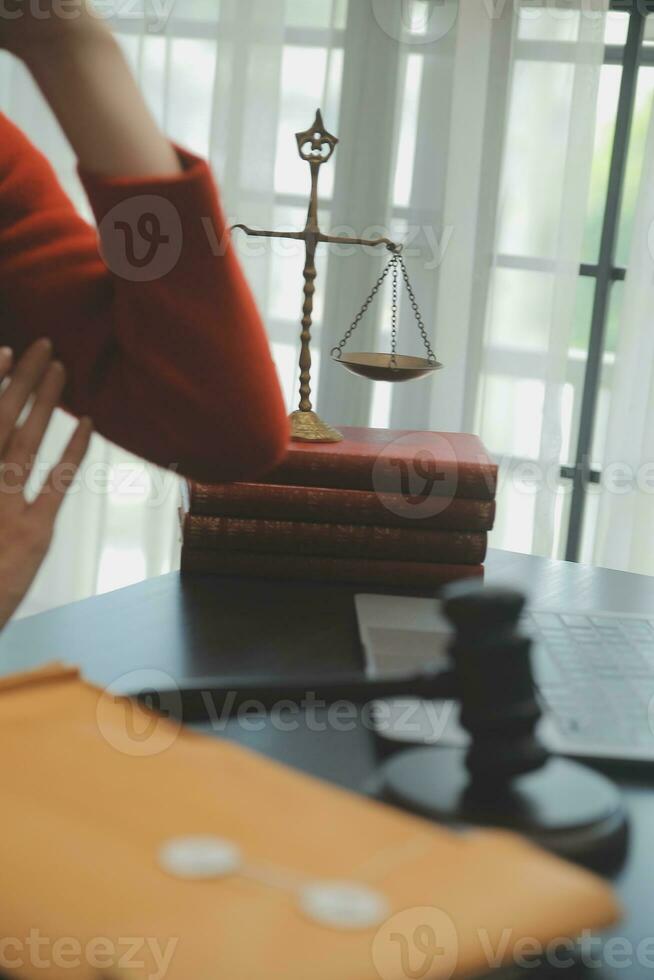 Business and lawyers discussing contract papers with brass scale on desk in office. Law, legal services, advice, justice and law concept picture with film grain effect photo