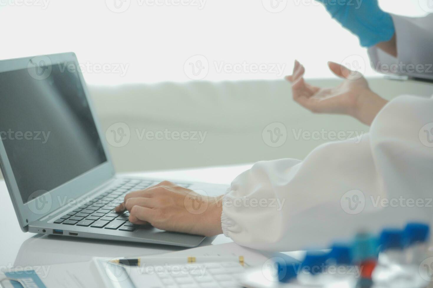 Health care researchers working in life science laboratory. Young female research scientist and senior male supervisor preparing and analyzing microscope slides in research lab. photo