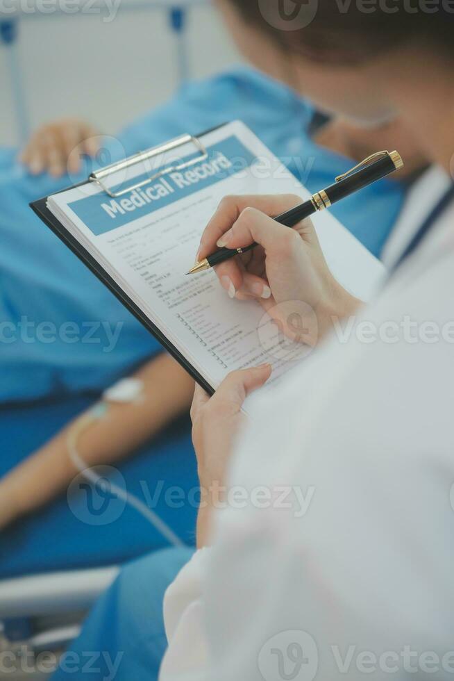 Doctor use stethoscope, checking up heart beat, lunch of auscultation in doctor office at hospital. Patient worker has to get medical checkup every year for her health or medical checkup cardiologist photo