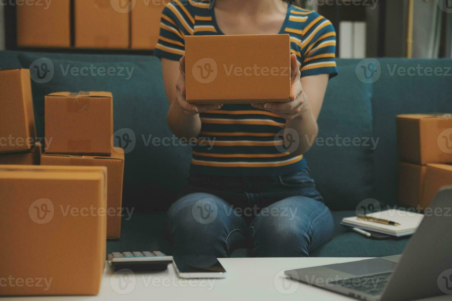 Entrepreneurs Small Business SME Independent men work at home Use smartphones and laptops for commercial checking, online marketing, packing boxes, SME sellers, concept, e-commerce team, online sales photo