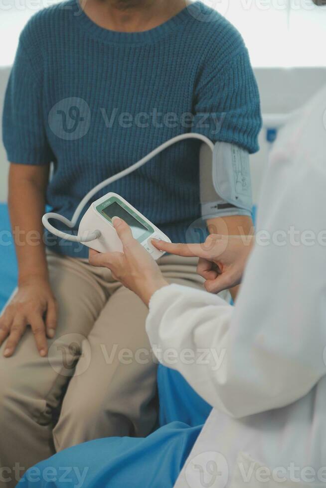 Doctor use stethoscope, checking up heart beat, lunch of auscultation in doctor office at hospital. Patient worker has to get medical checkup every year for her health or medical checkup cardiologist photo