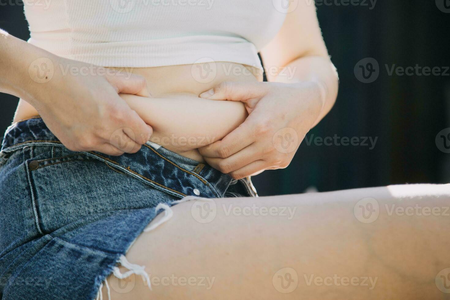 fat woman, fat belly, chubby, obese woman hand holding excessive belly fat with measure tape, woman diet lifestyle concept photo