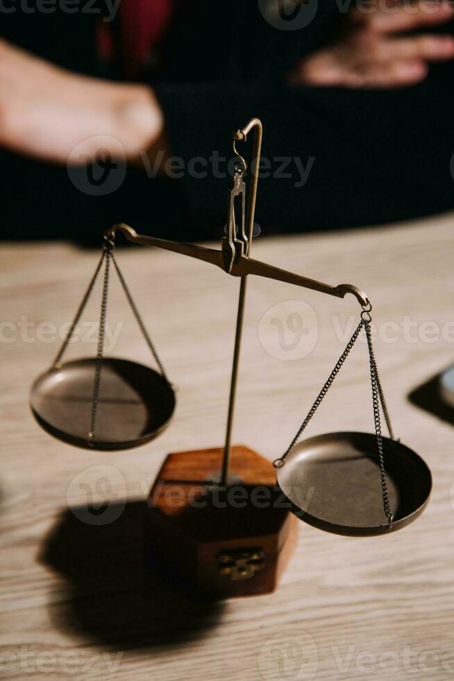 Justice and law concept.Male judge in a courtroom with the gavel, working with, computer and docking keyboard, eyeglasses, on table in morning light photo