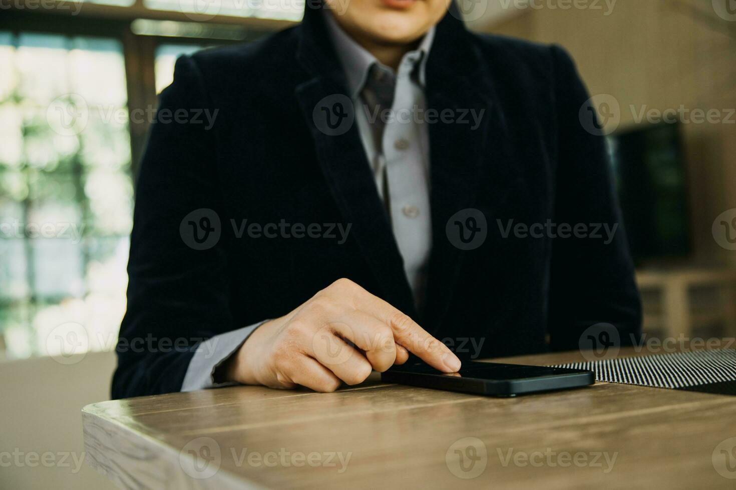 Mature businessman using a digital tablet to discuss information with a younger colleague in a modern business lounge photo