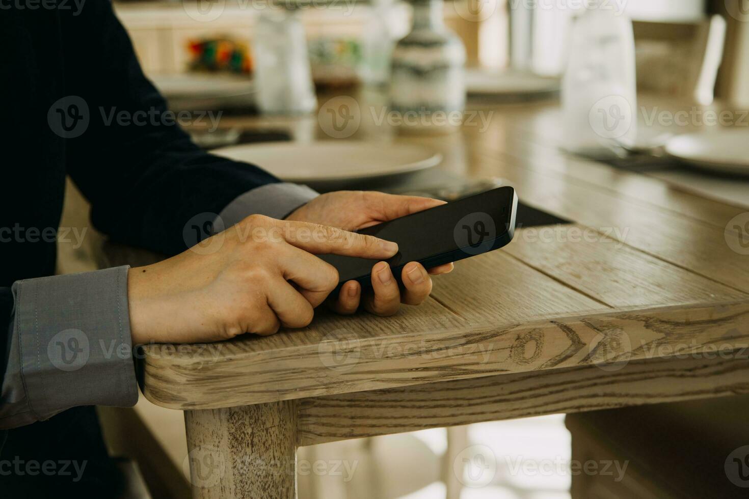 Mature businessman using a digital tablet to discuss information with a younger colleague in a modern business lounge photo