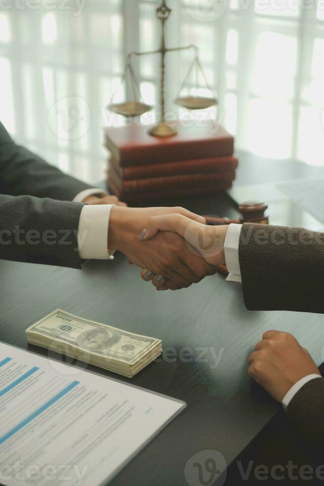 Business and lawyers discussing contract papers with brass scale on desk in office. Law, legal services, advice, justice and law concept picture with film grain effect photo