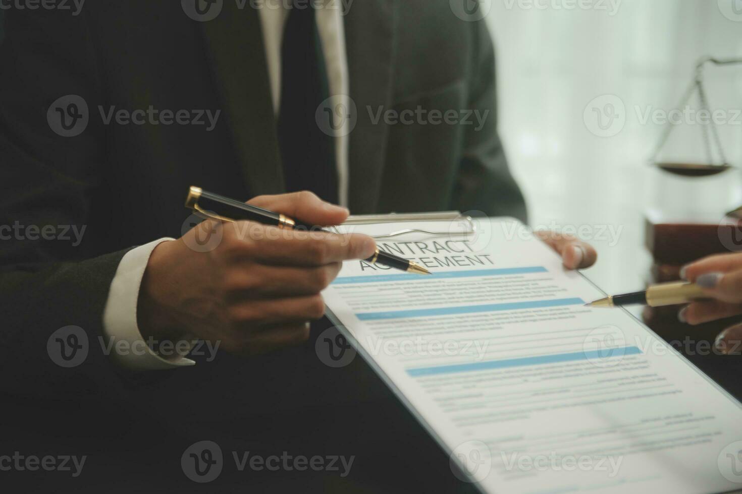 Business and lawyers discussing contract papers with brass scale on desk in office. Law, legal services, advice, justice and law concept picture with film grain effect photo