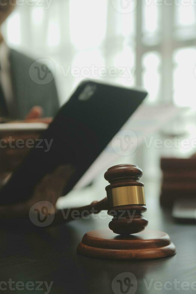 Business and lawyers discussing contract papers with brass scale on desk in office. Law, legal services, advice, justice and law concept picture with film grain effect photo