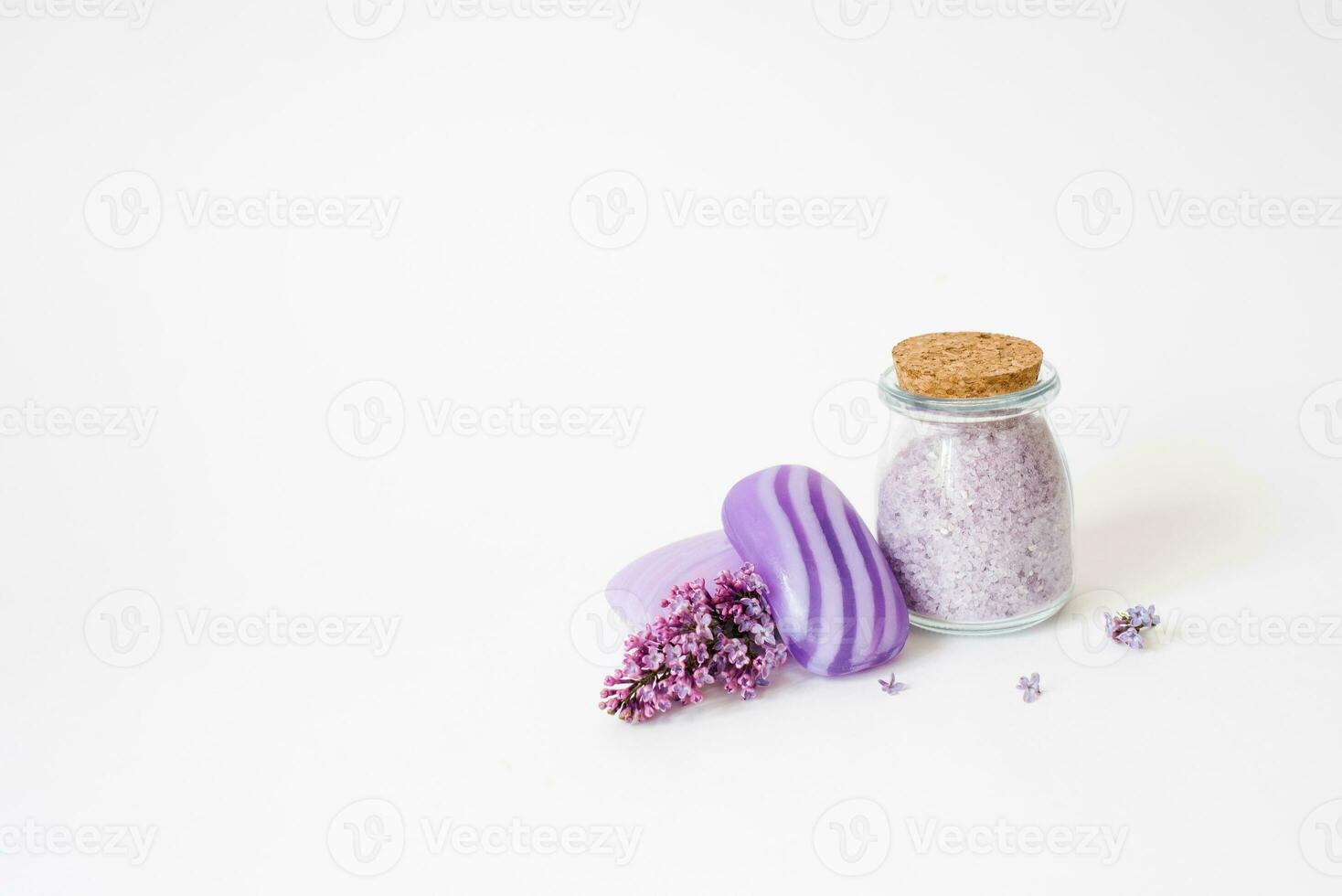 Aromatic spa set. Sea salt for body care, natural soap, candle and lilac flowers on a light background photo