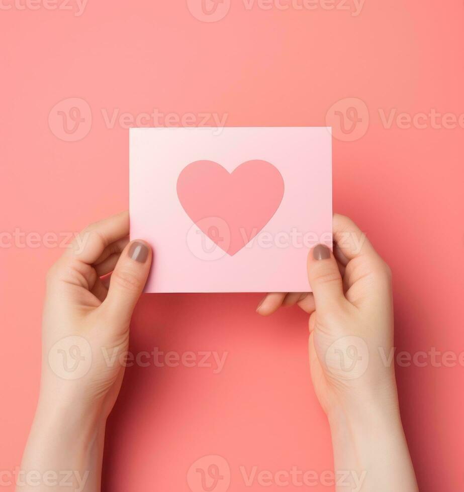 Woman holding pink heart card photo