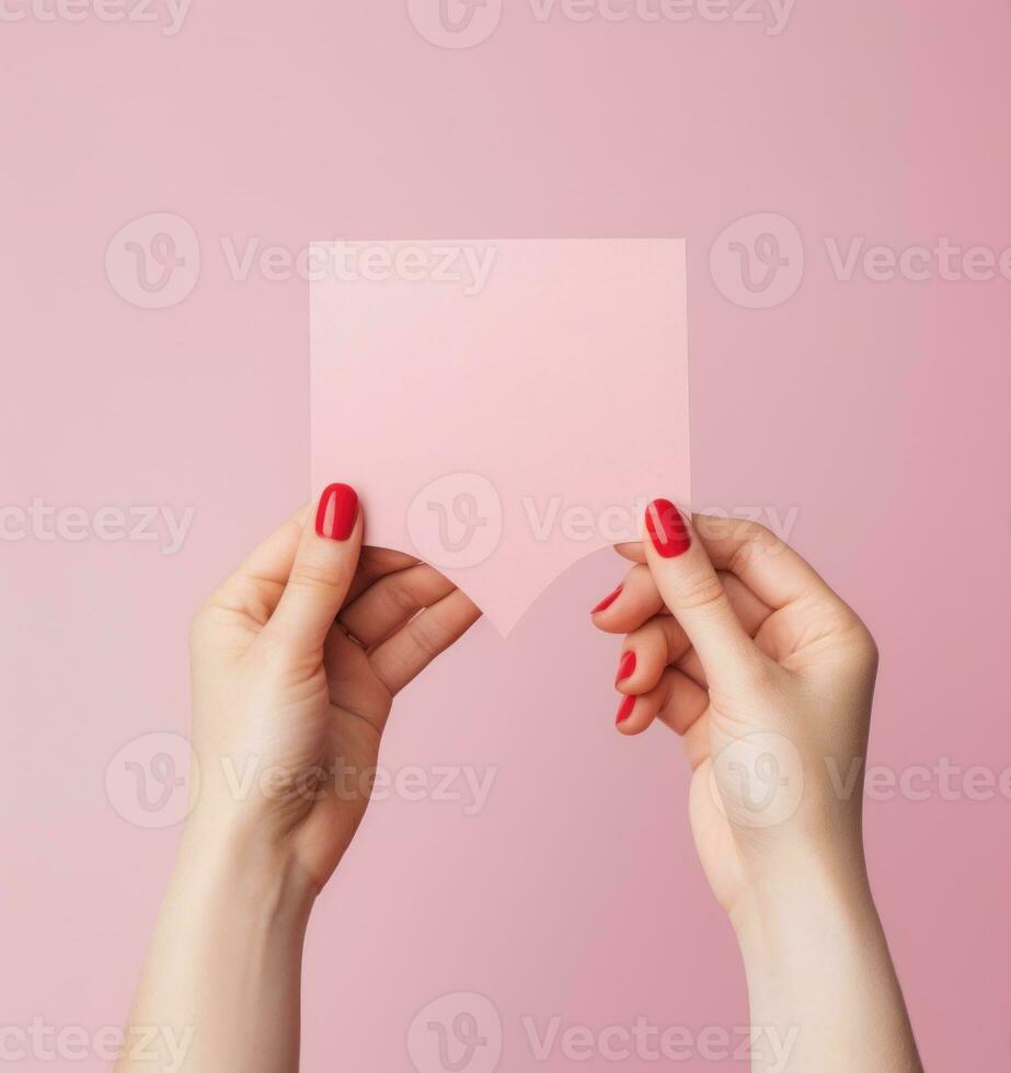 Woman holding pink heart card photo