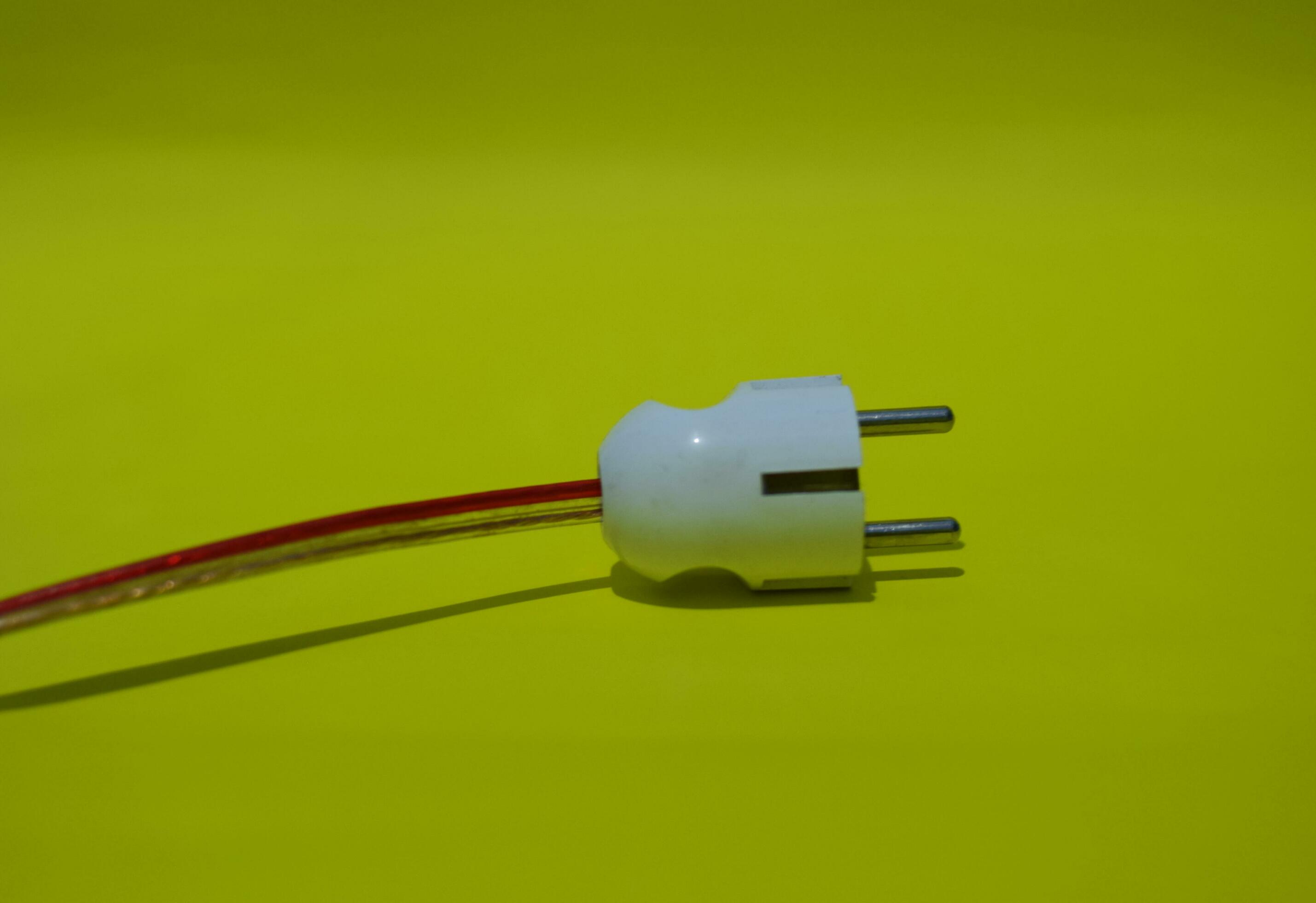 Close up of electrical plug socket isolated on yellow background