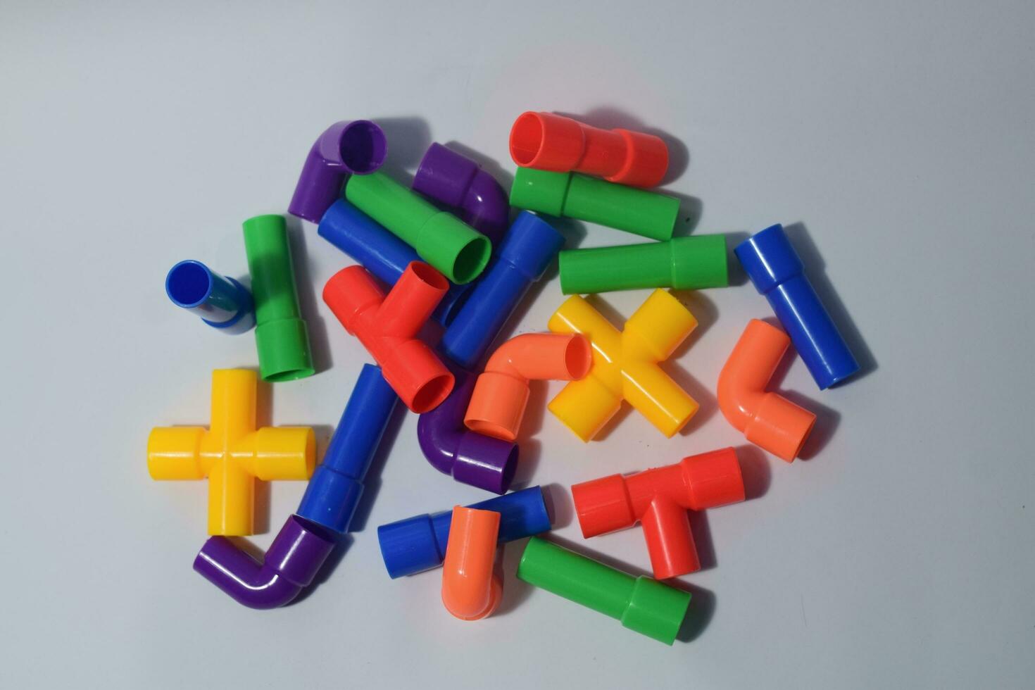 Colorful plastic pipe block puzzle. Pipe building block. Educational toys. Flat lay photo