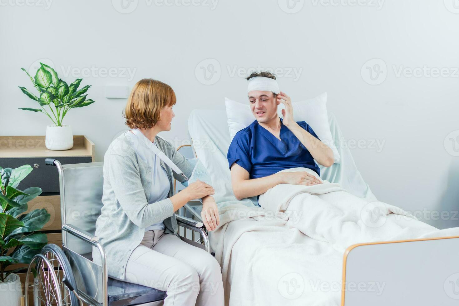 The patient has a headache while lying in the hospital room with Gauze Bandage Wrapped Around Head. photo