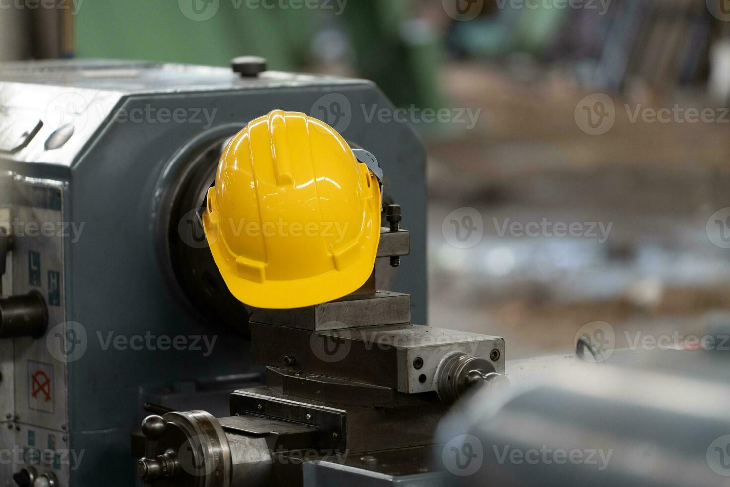 Yellow helmet with machinery, the background is factory photo