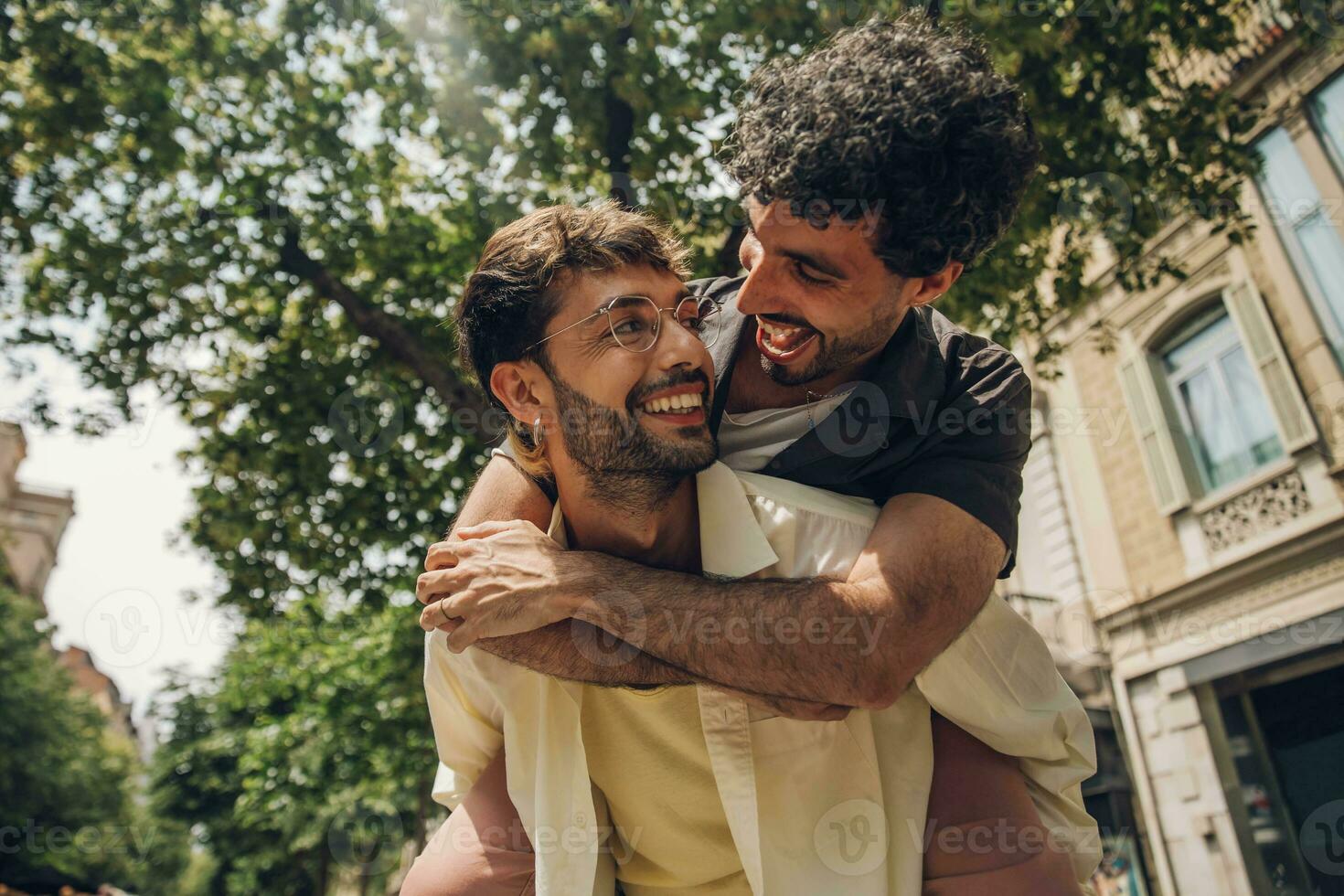 Happy gay couple kissing in the park. LGBT gay couple concept. photo