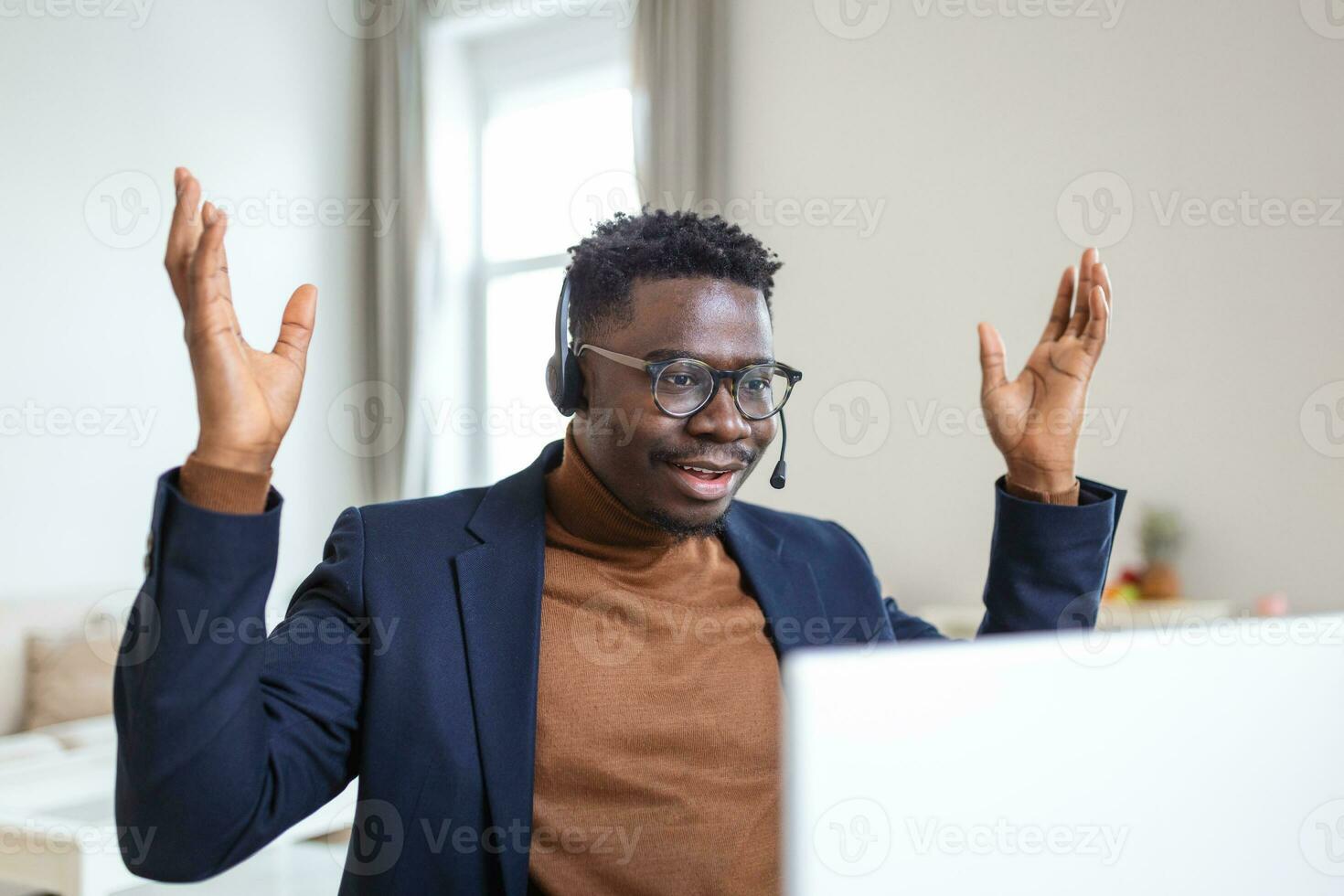 Excited African American man wearing headphones reading good news in email, getting new job, promotion, using laptop, looking at screen and screaming with joy, showing yes gesture, celebrating photo