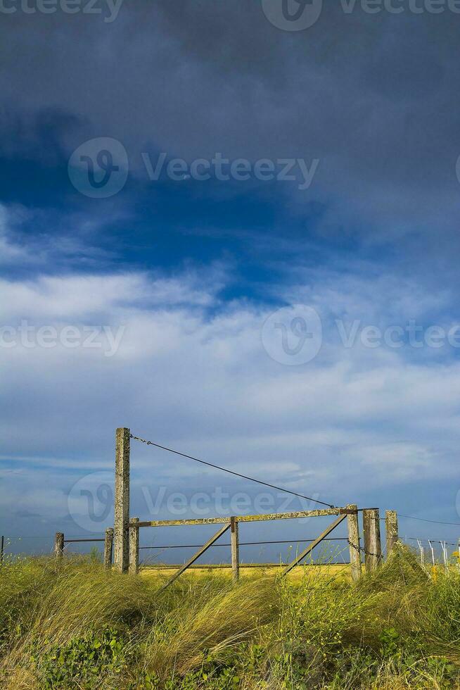 a fence with a gate and a gate post photo