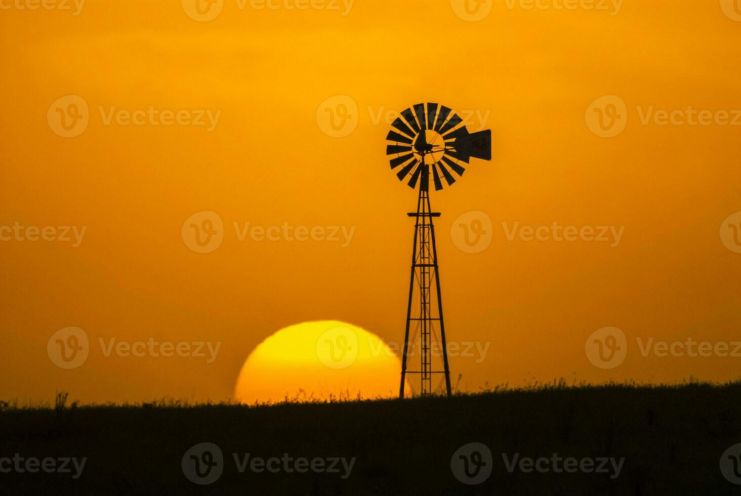 a windmill and a sunset in the background photo