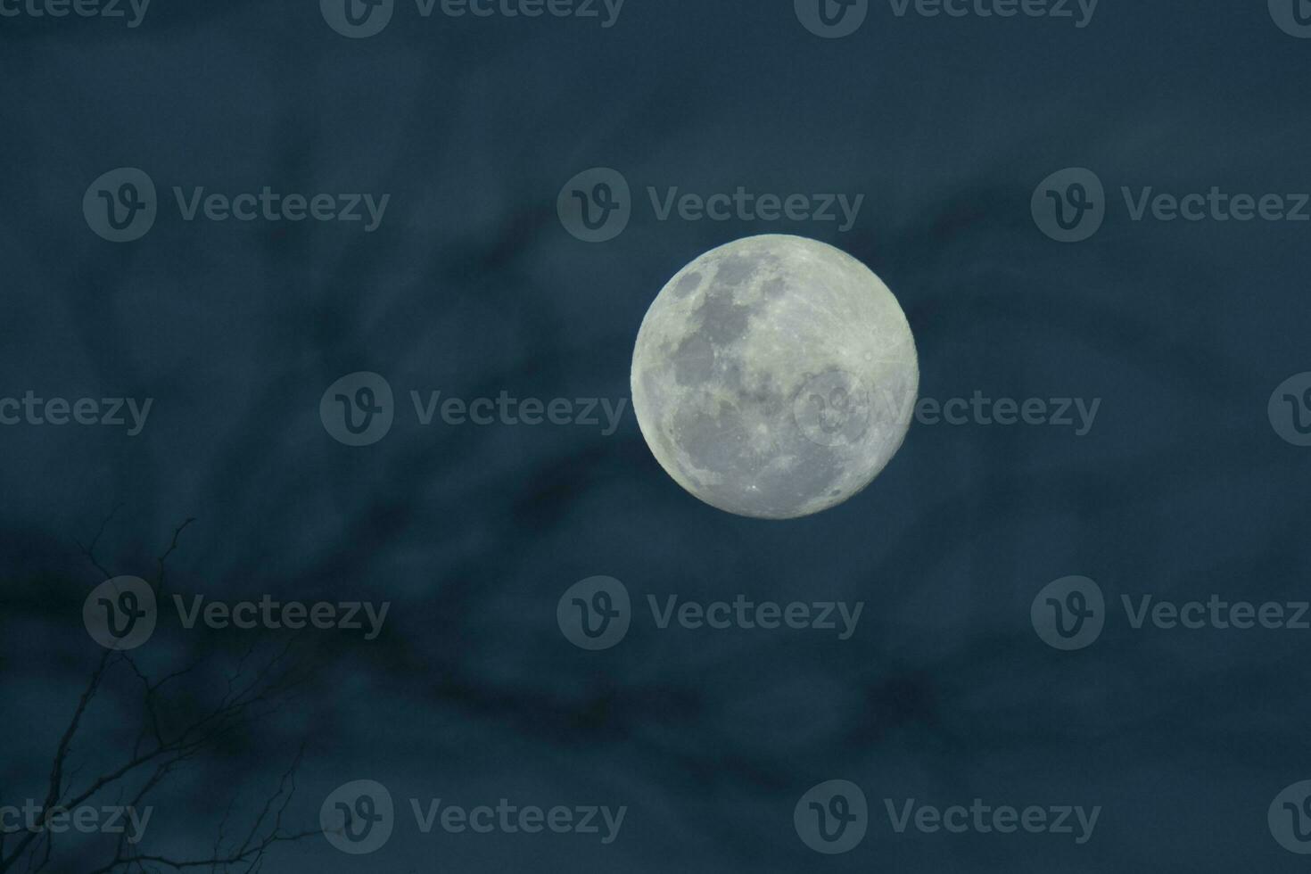 a full moon is seen in the sky with a purple and blue background photo