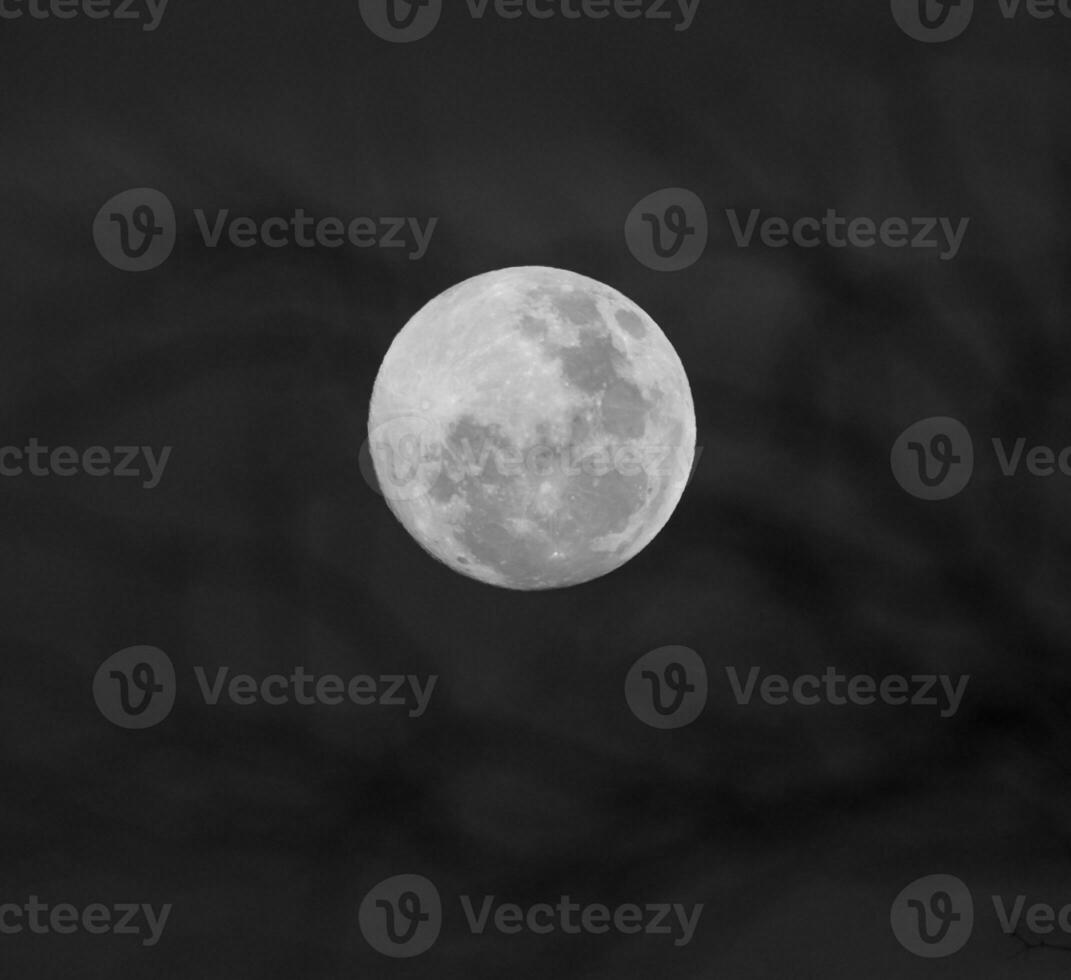 a full moon is seen in the sky with a purple and blue background photo