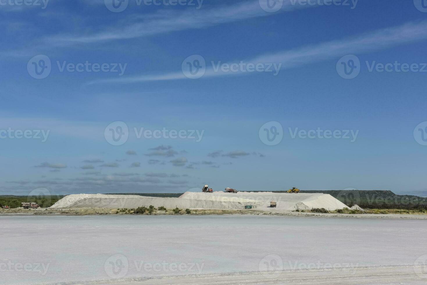 a large salt flat with a large building in the background photo