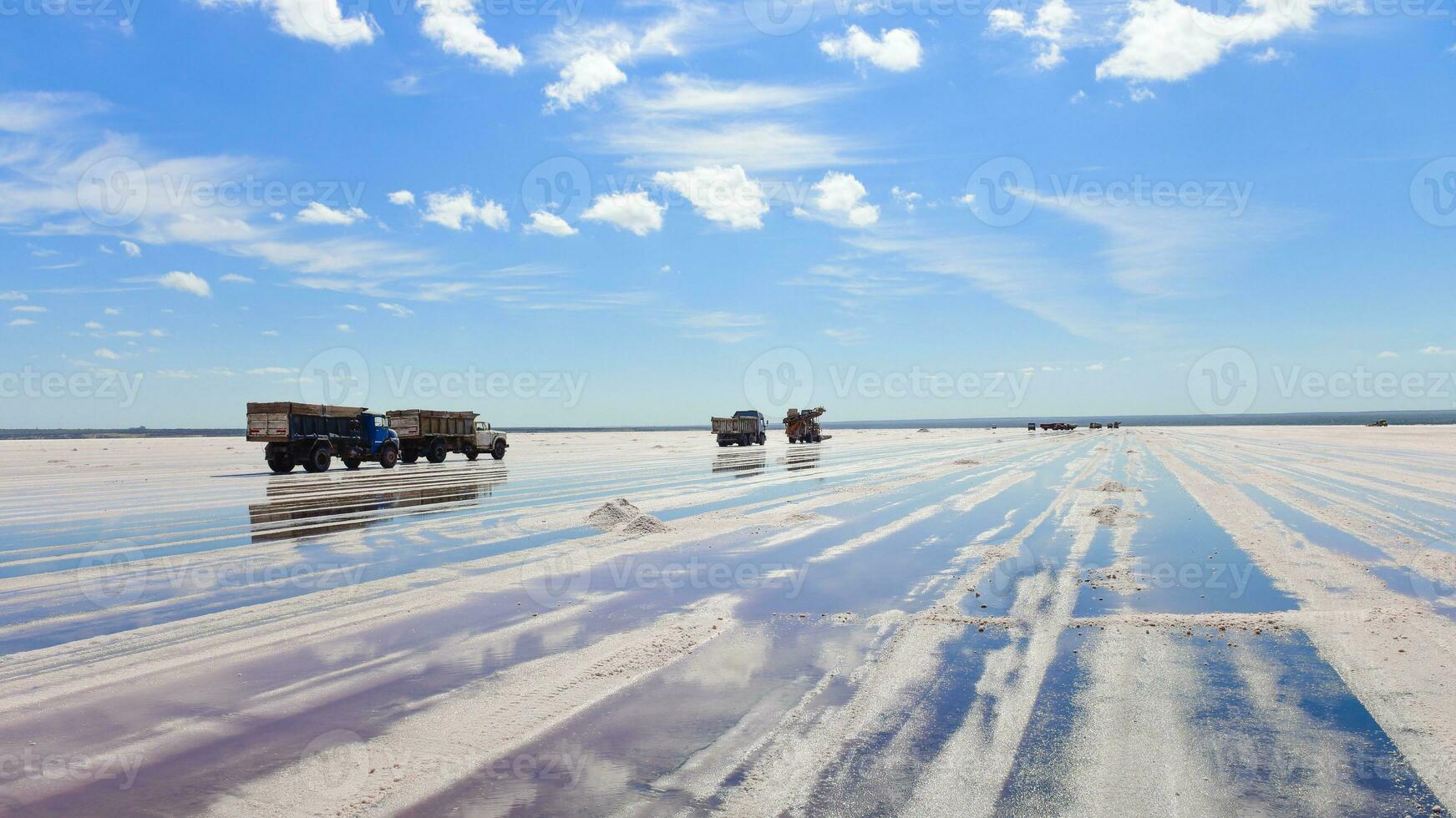 a truck is driving on a salt flat photo