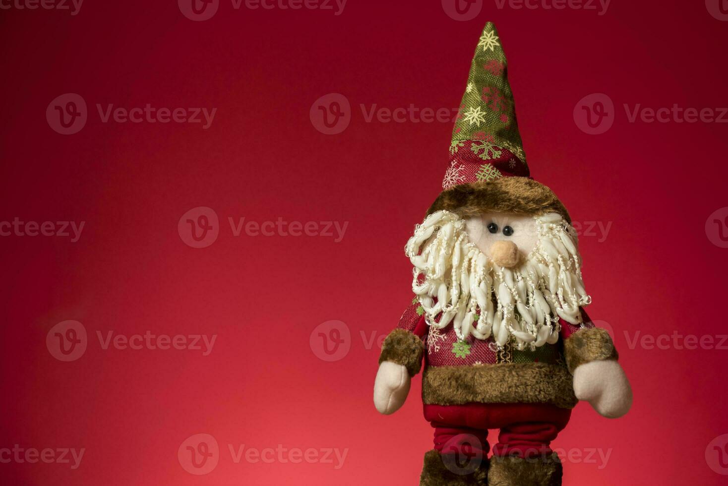 a santa claus doll with a beard and hat photo