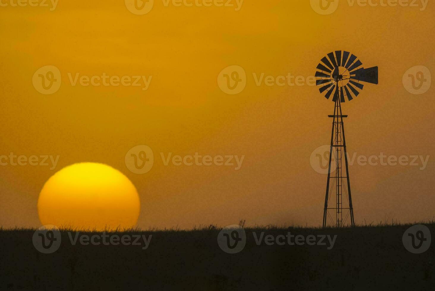 a windmill and a sunset in the background photo