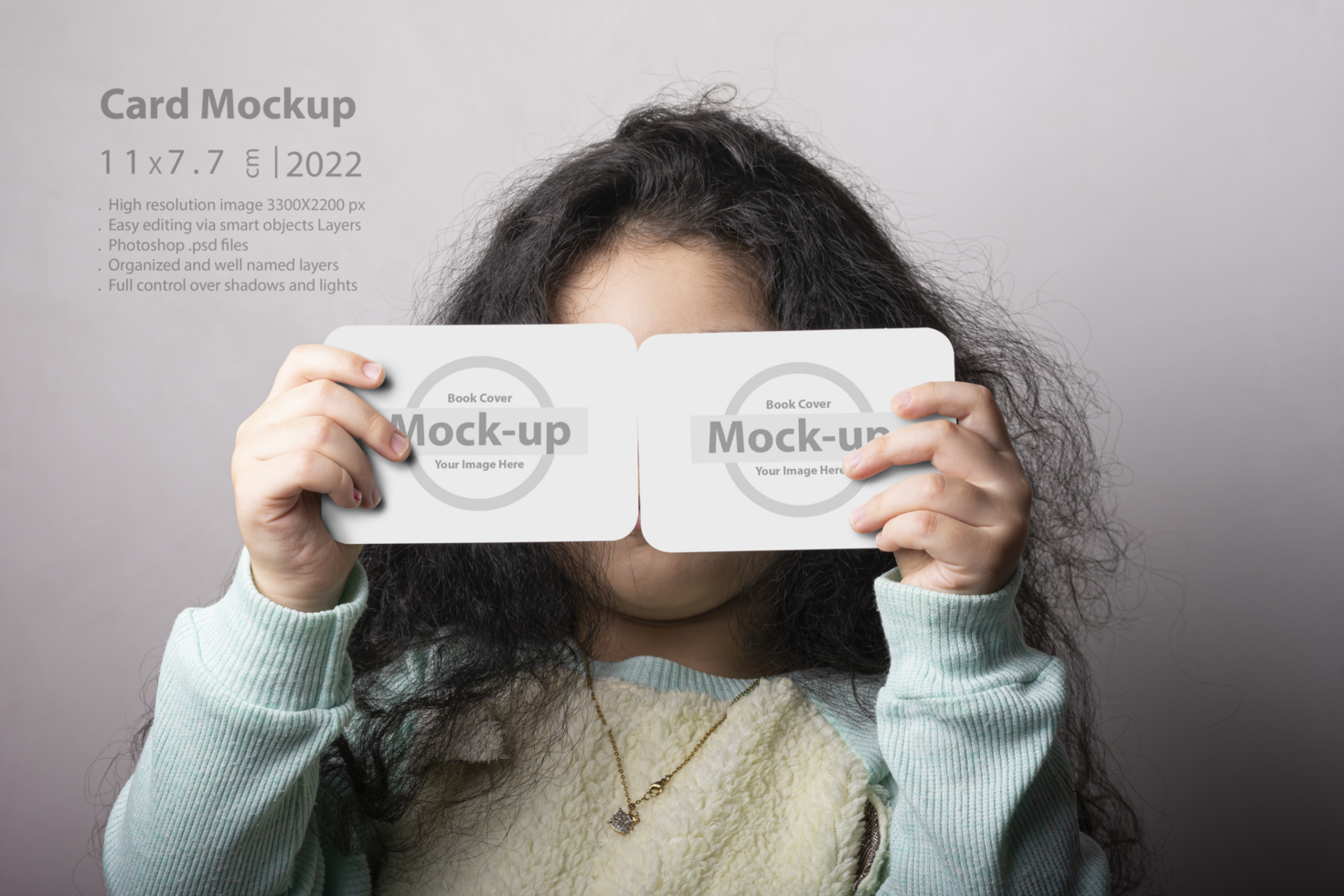 Little girl portrait holding two flash card in front of face psd