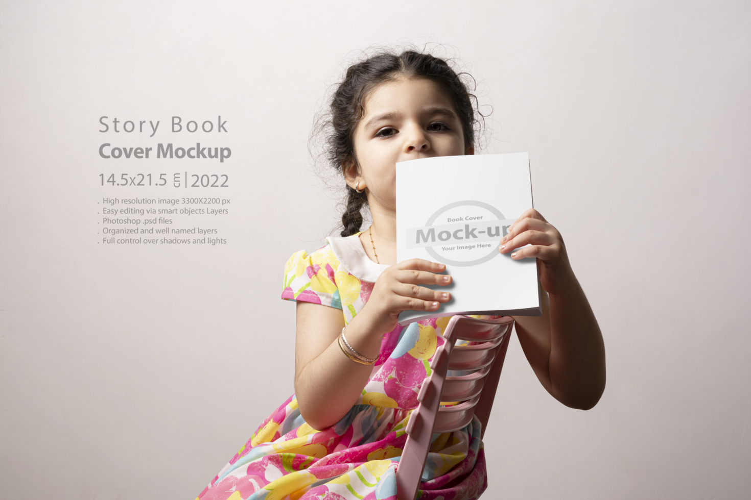 Little girl holding a book with blank cover in front of body mock-up series 316 psd