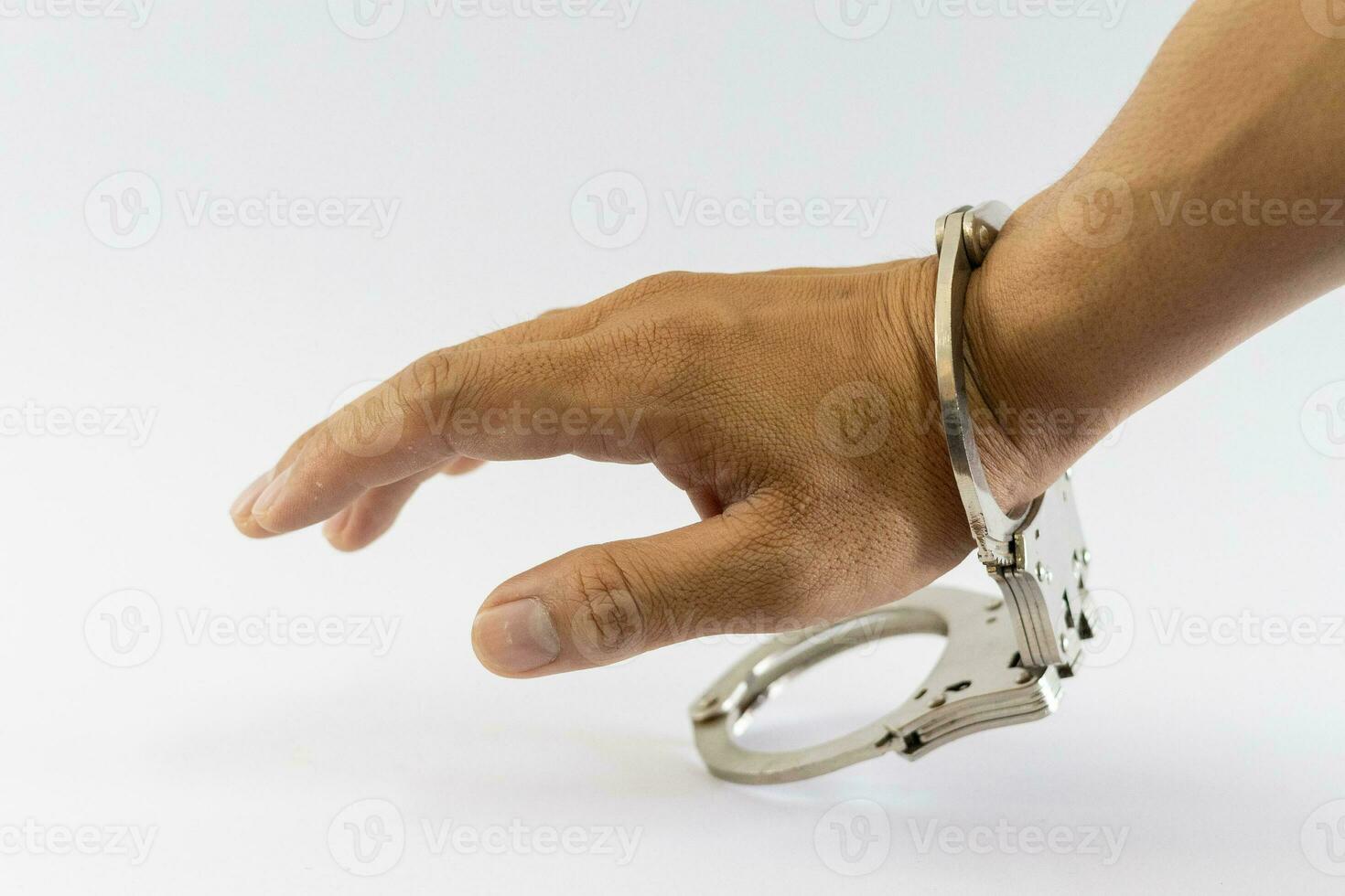 Man's hand in handcuffs, one side, white background photo