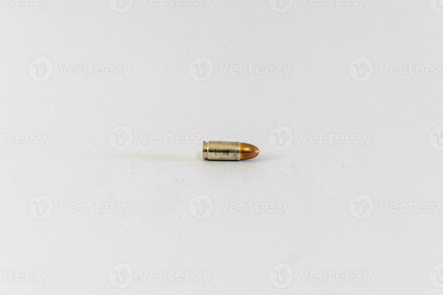 Golden 9mm cartridge. Isolated on white background. photo