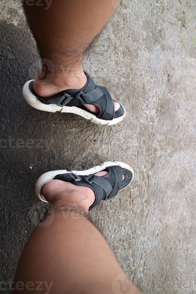 Photo of Asian or oriental male feet wearing sandals