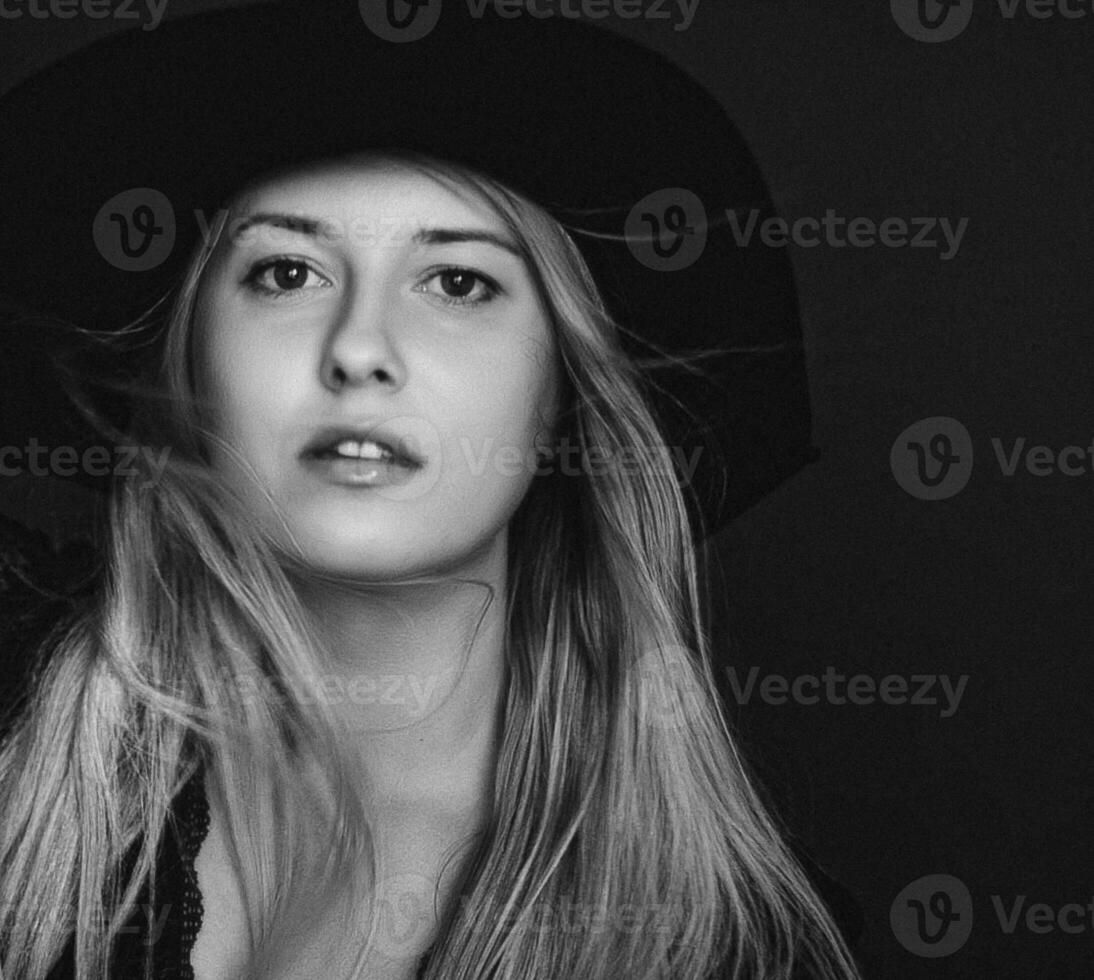 Beautiful blonde woman wearing a hat, artistic film portrait in black and white for fashion campaign and beauty brand photo