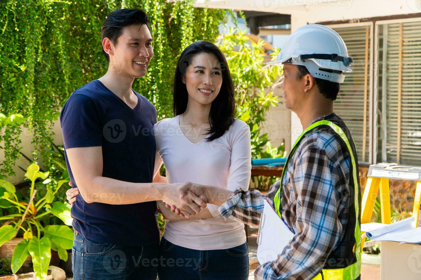 Happy homeowner stand in front of contractor and shake hand, handyman holding clipboard and after checking details before renovations home, house improvement interior, Interior design photo