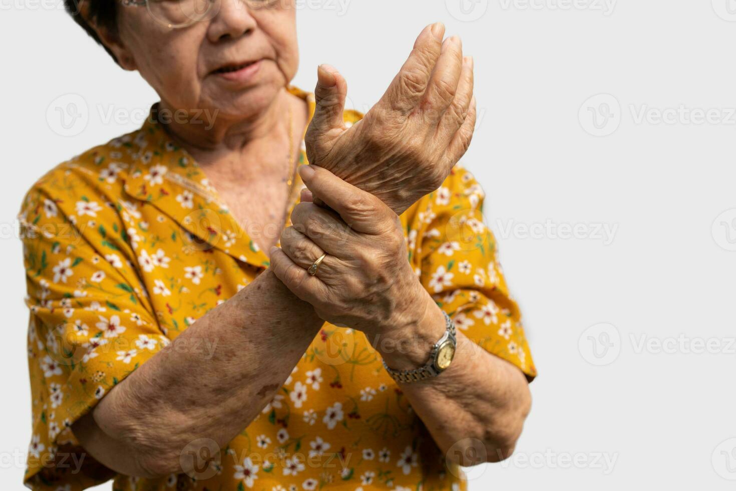 Elderly Asian woman patients suffer from numbing pain in hands from rheumatoid arthritis. Senior woman massage her hand with wrist pain. Concept of joint pain, rheumatoid arthritis, and hand problems. photo