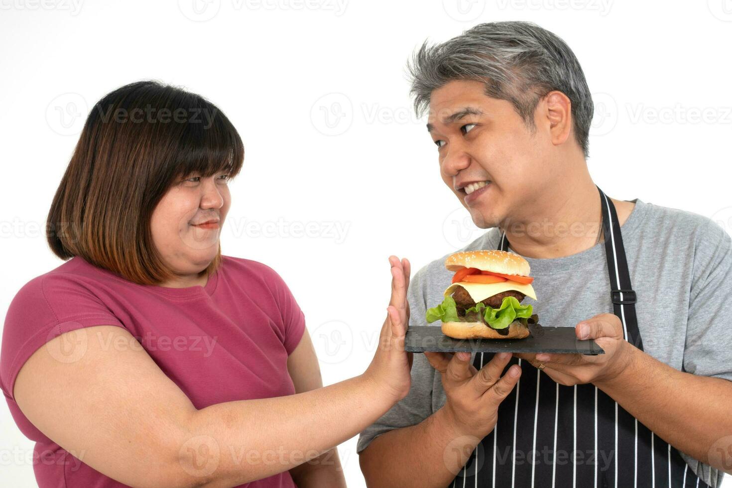 The fat Asian healthy woman Refuse to eat the burger. Concept of healthcare and nutritious food photo