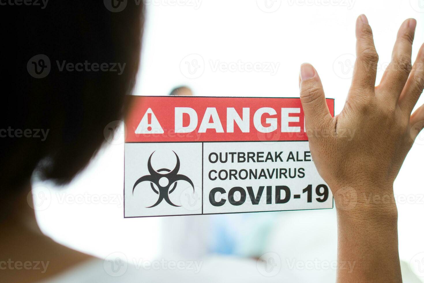 A Wife standing in front of the Quarantine room And put a hand on the mirror While waiting for the examination results, She has a lot of anxiety. Concept of Disease treatment and coronavirus vaccine photo