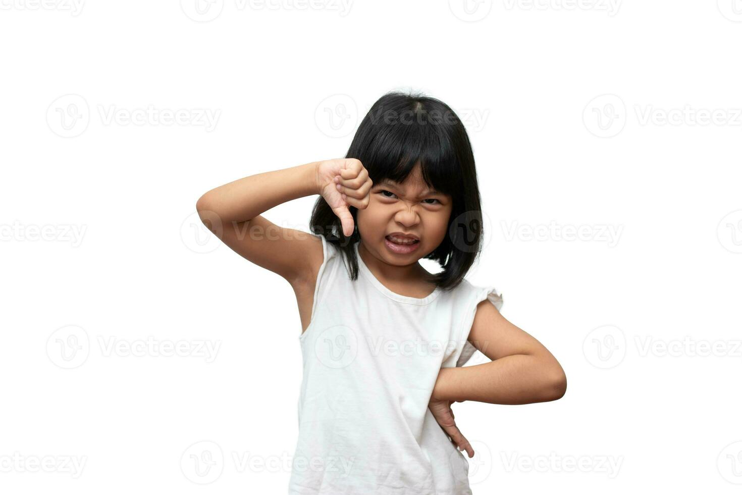 Portrait of Asian angry and sad little girl and thumbs down on white isolated background, The emotion of a child when tantrum and mad, expression grumpy emotion. Kid emotional control concept photo