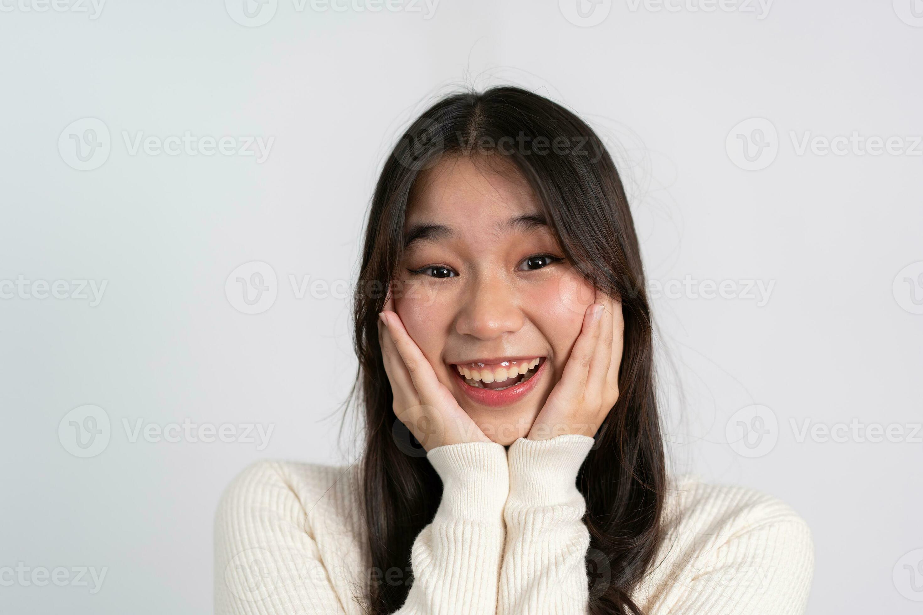 Happy cheerful young Asian girl with long light hair smiling brightly  feeling happy with a positive expression, joyful surprise funky, Female in  black with a big smile isolated on white background. 26643881