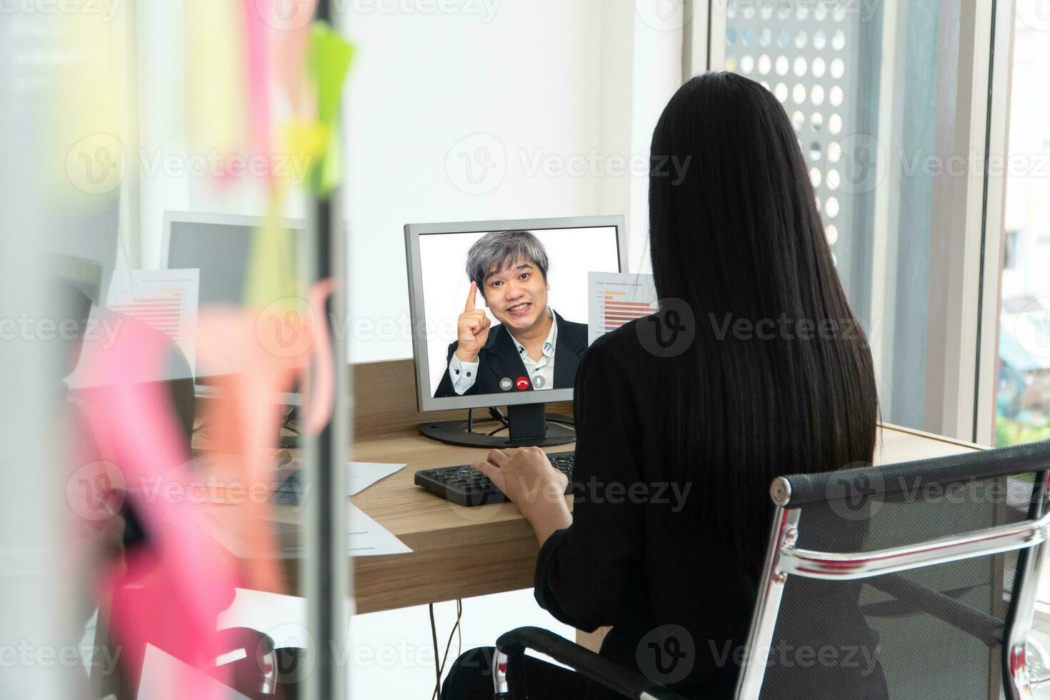 Asian Businessman making a video call to customer for talking and presenting work through the video conference. Concept of virtual  communication technology working together photo