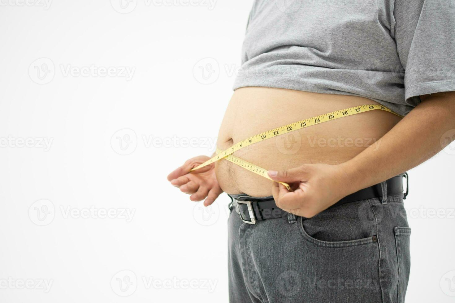 Overweight Man uses a measurement tape for measures his fat belly. isolated on white background. Concept of Healthcare, medicine, and  Weight loss photo