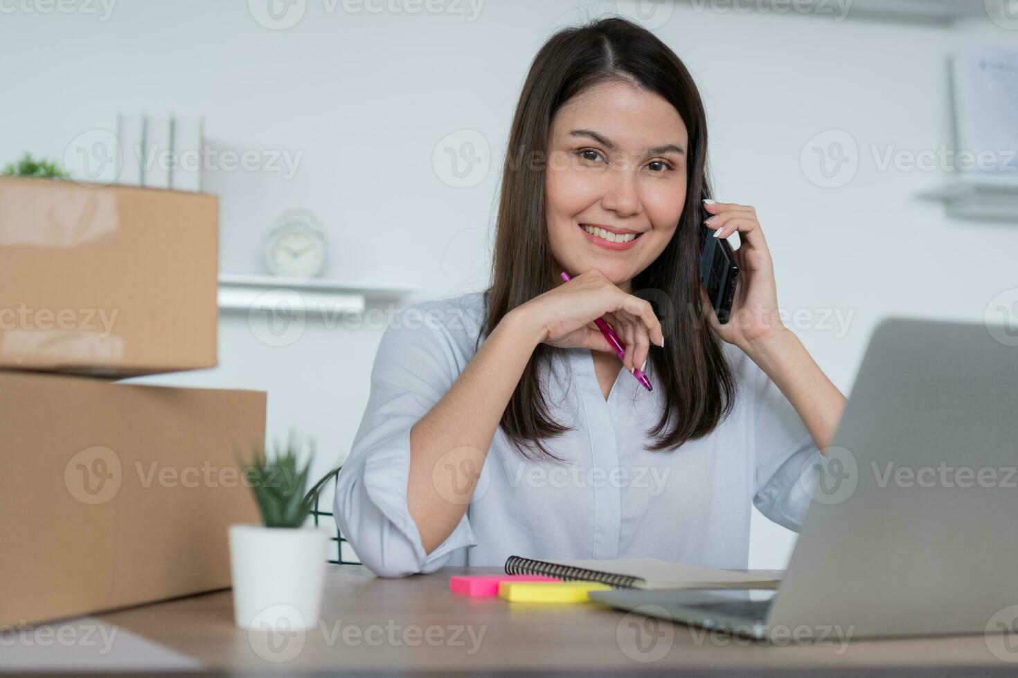 Happy young Asian woman entrepreneur, talk with a supplier and Smile for sale success of online shopping store at home office, Concept of the merchant, small business, online business, and eCommerce. photo